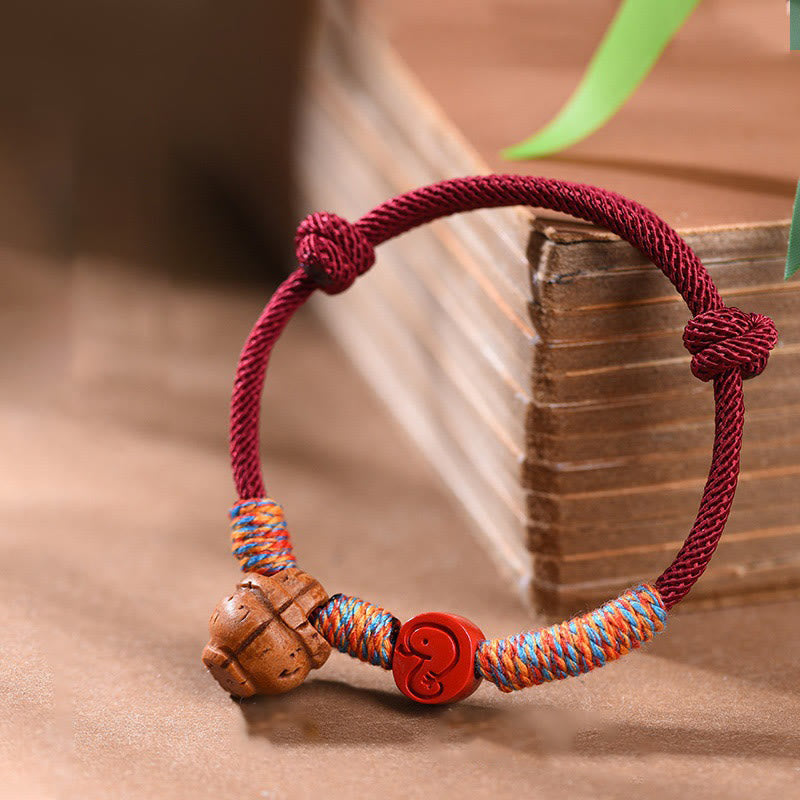 Buddha Stones Handmade Chinese Zodiac Red String Peach Pit Cinnabar Luck Bracelet - Snake - Red Rope(Wrist Circumference: 14-17cm) - image 0